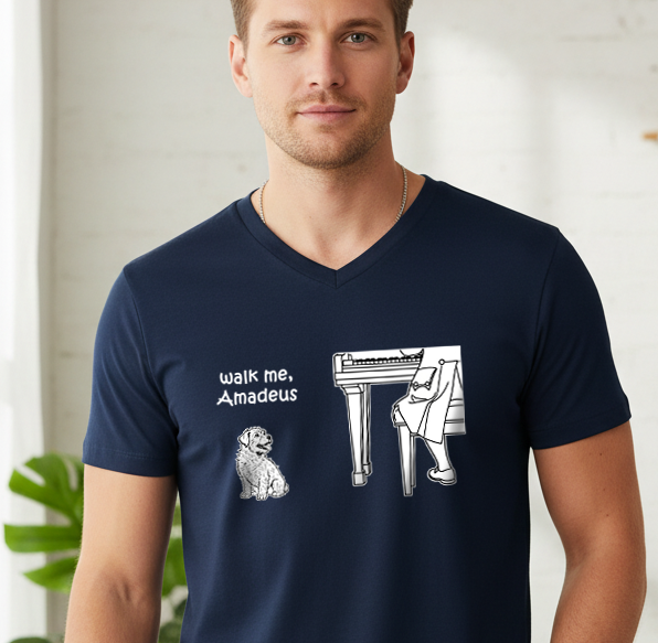 A man wearing a navy blue V-neck t-shirt with a white graphic print that reads 'walk me, Amadeus' next to an illustration of a Terrier Mix dog and a pianist. 