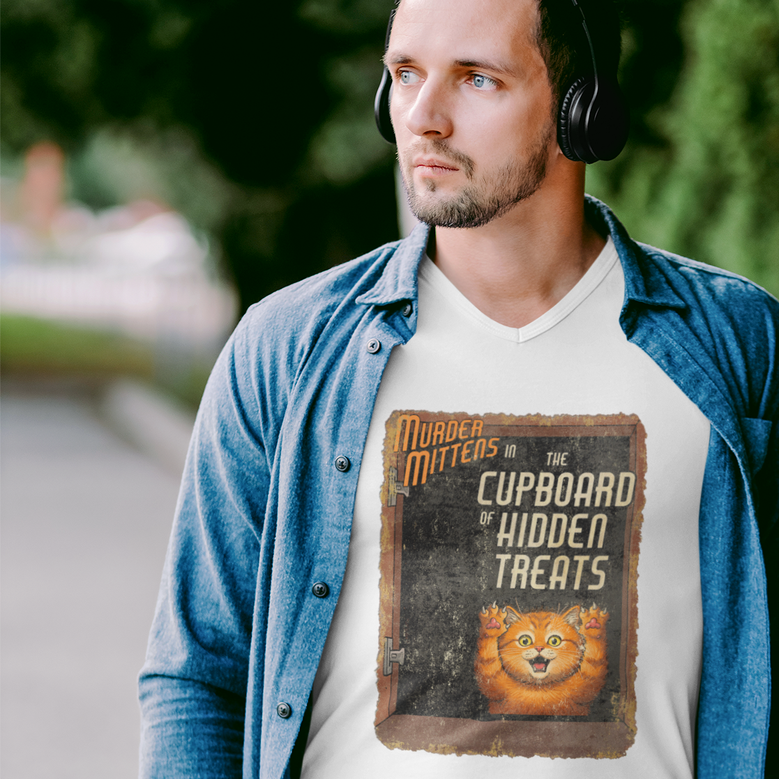 A man wearing a white graphic t-shirt with the caption, 'Murder Mittens in the Cupboard Hidden Treats'.