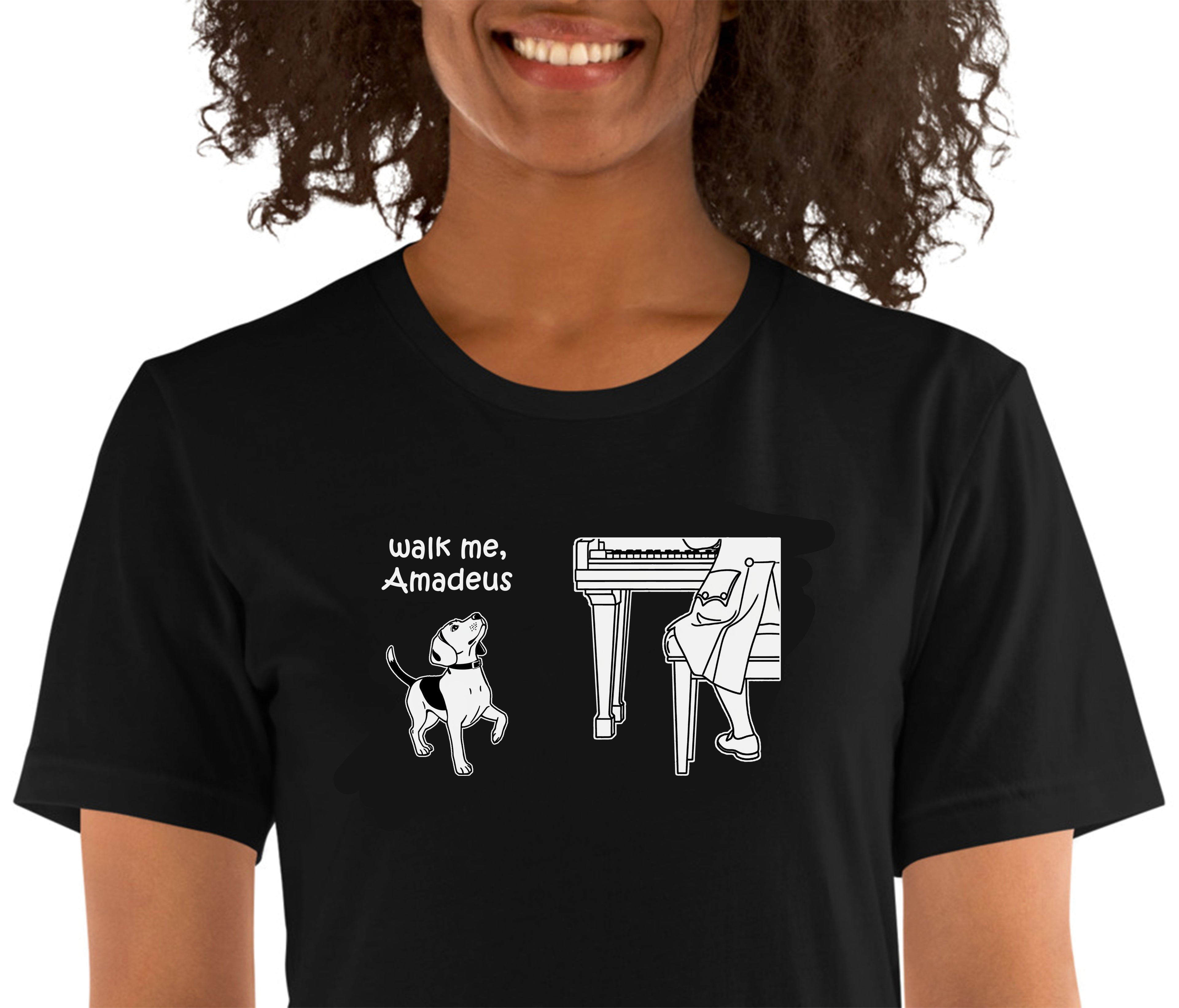 A woman wearing a black short-sleeve t-shirt with a white graphic print that reads 'walk me, Amadeus' next to an illustration of a dog and a pianist.